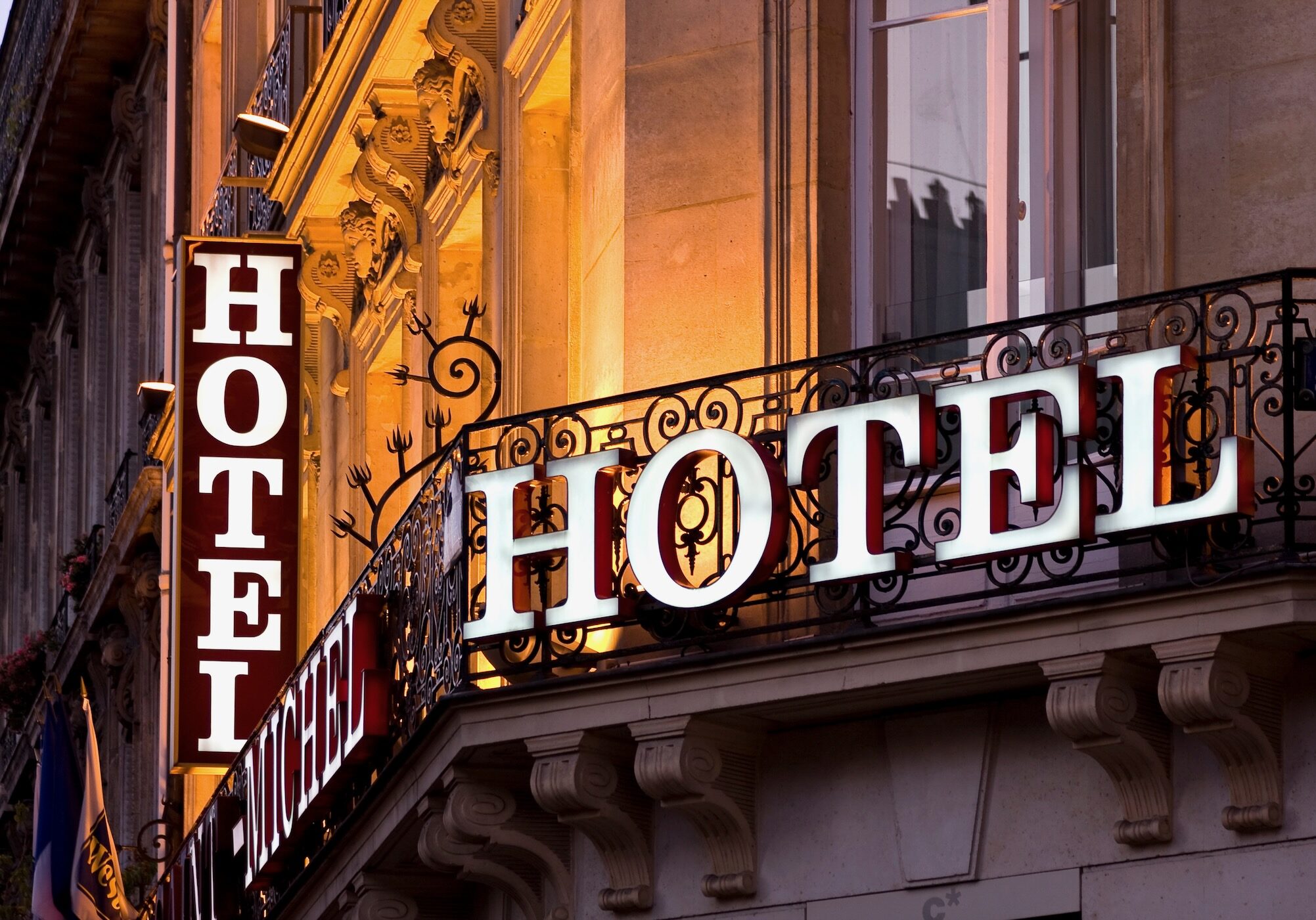 Illuminated Parisian hotel sign taken at dusk